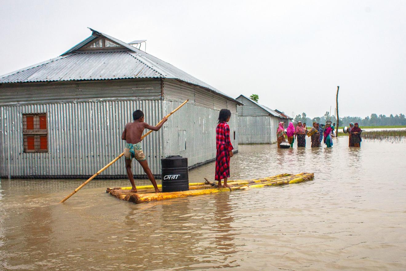 people wading through flood waters